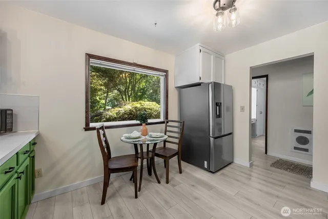 a kitchen with stainless steel appliances granite countertop a refrigerator and a stove top oven