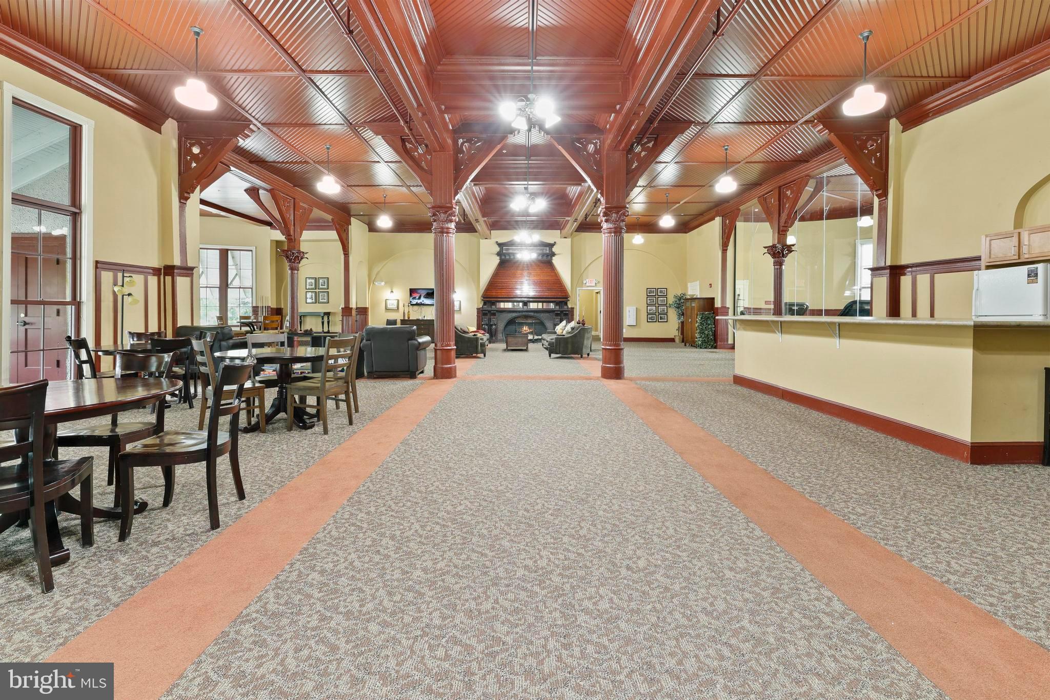 9610 Dewitt Drive, Unit BB03 Silver Spring, MD 20910 - Photo 24 of 28 a large room with lots of tables a large window and chairs