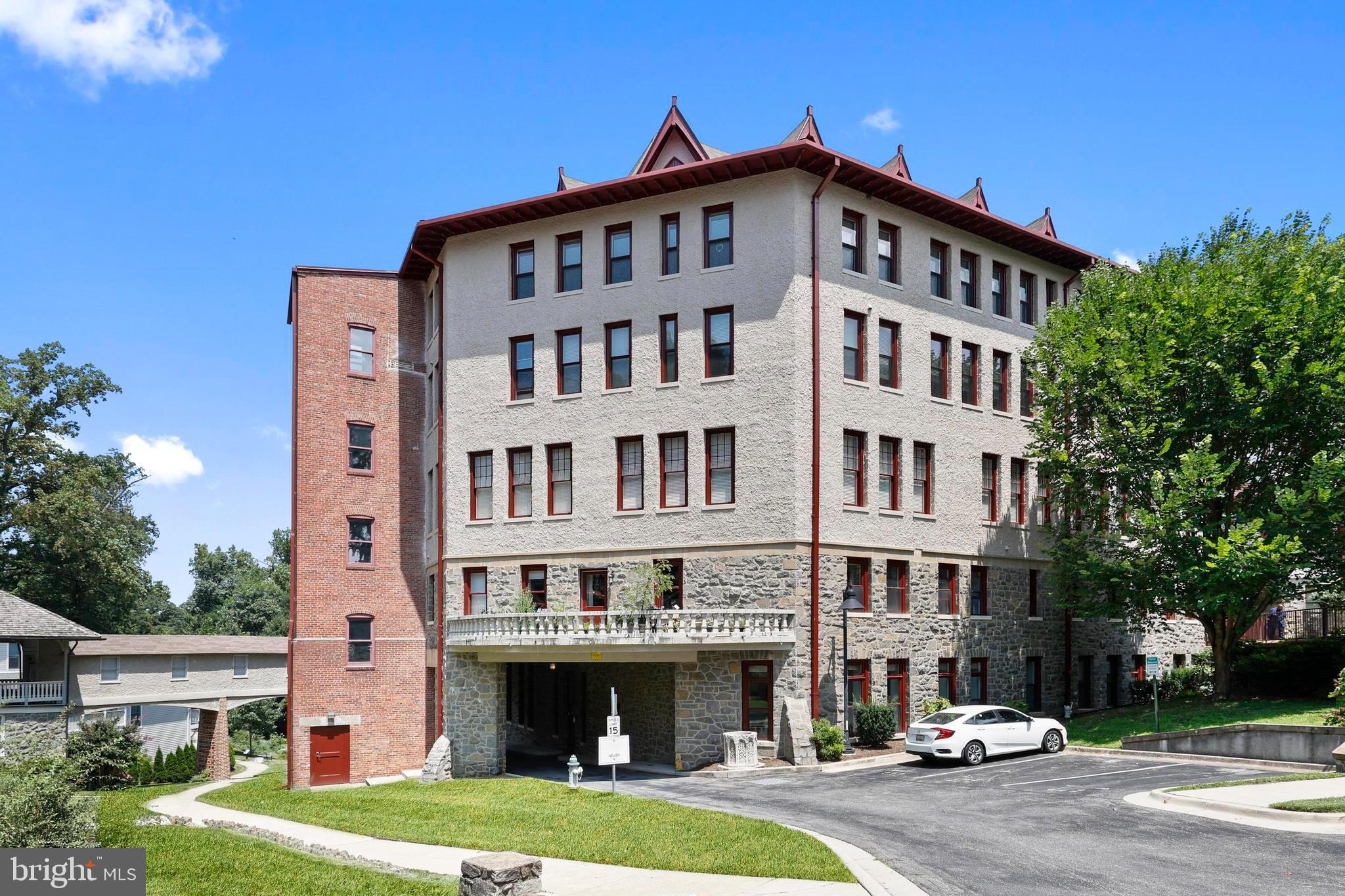 9610 Dewitt Drive, Unit BB03 Silver Spring, MD 20910 - Photo 26 of 28 a front view of a building with a yard