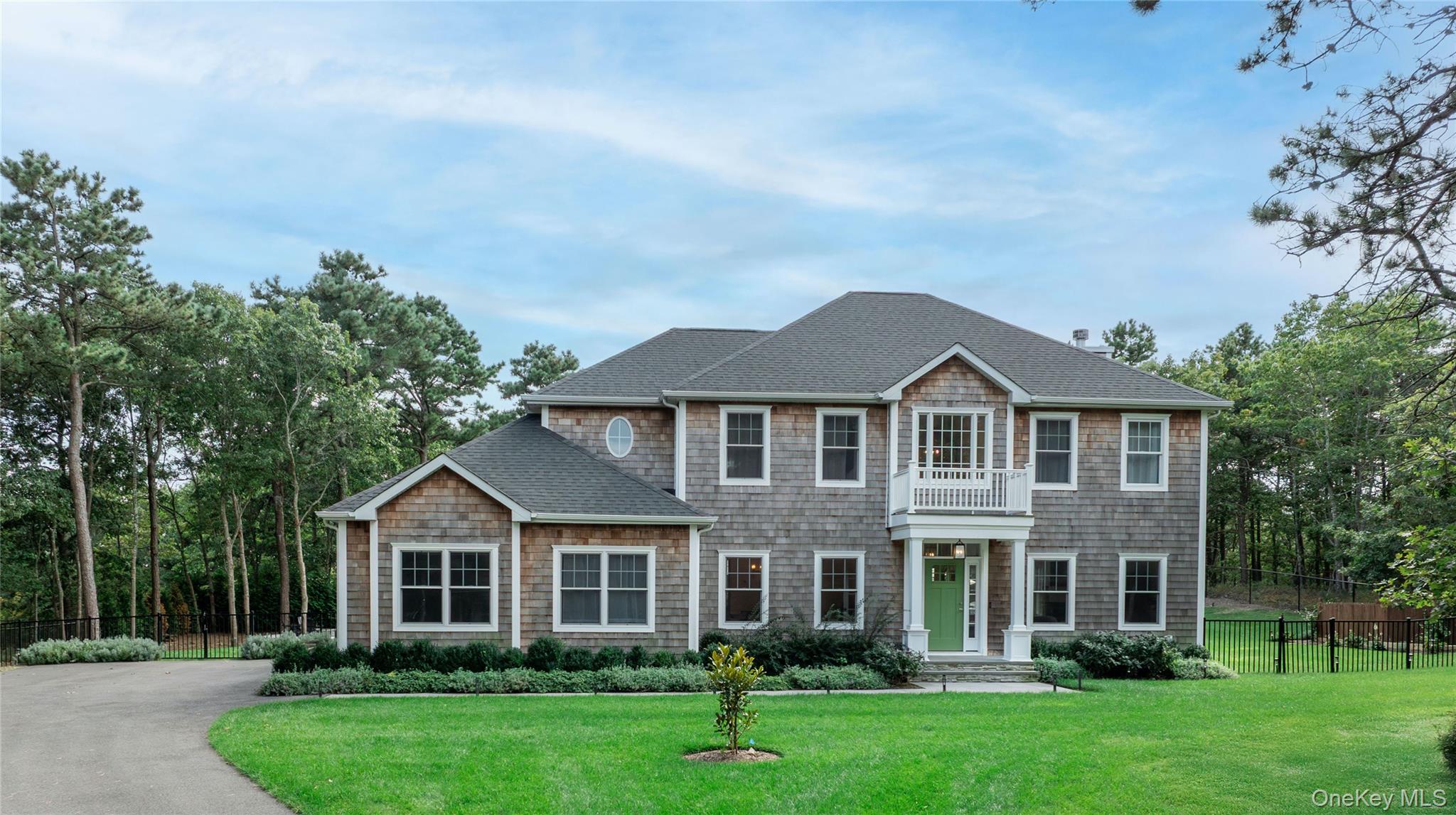 View of front of home with a shingled roof