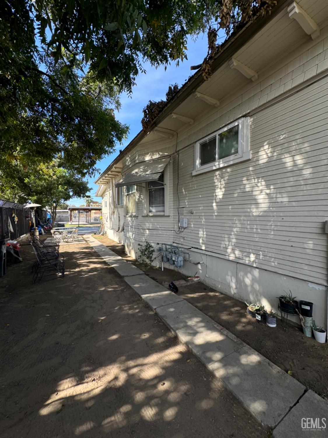 Undisclosed Address Fresno, CA 93728 - Photo 3 of 31 a front view of a house with a yard