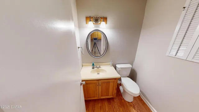 a bathroom with a toilet a sink and a mirror