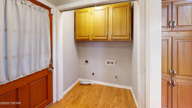 a view of a bathroom with a tub and windows