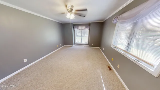 a view of an empty room with a window