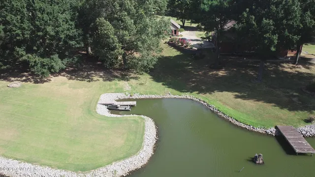 an aerial view of a house a yard and a swimming pool
