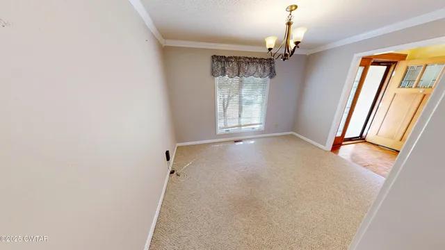 an empty room with windows and entrance