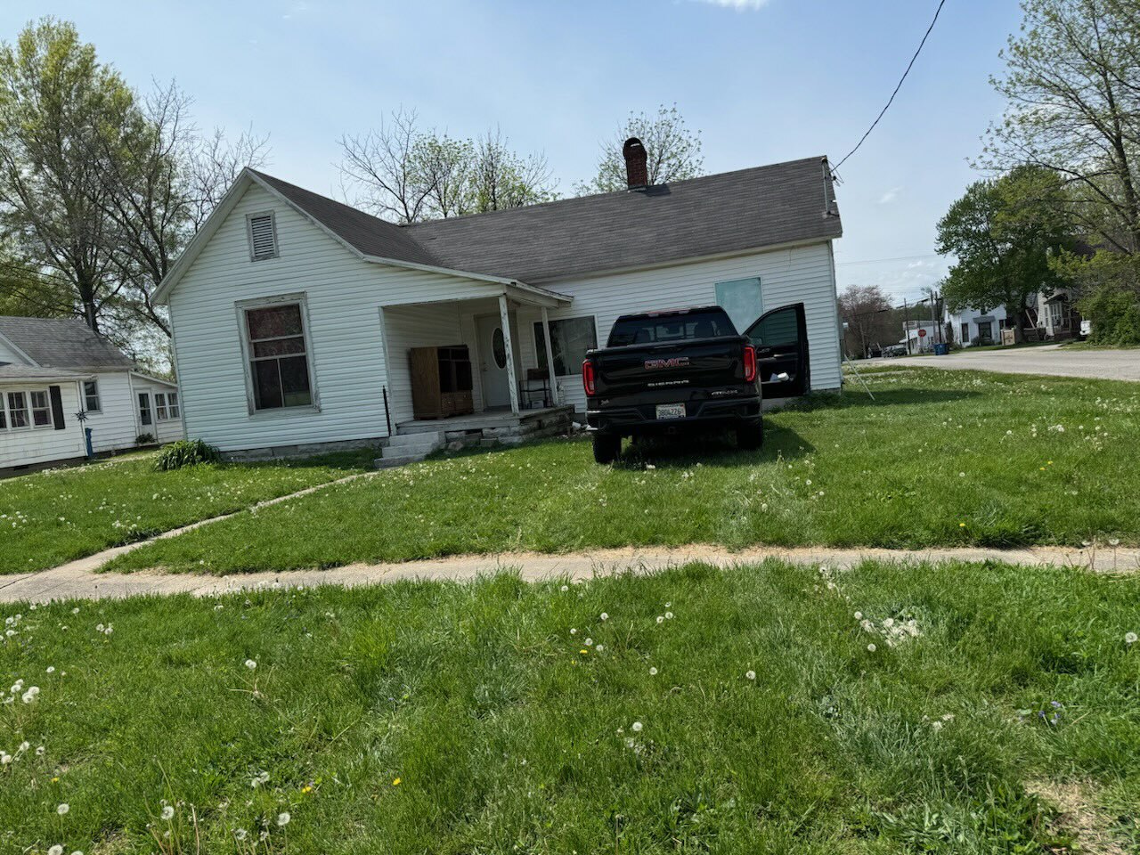 a view of a house with a yard and sitting area
