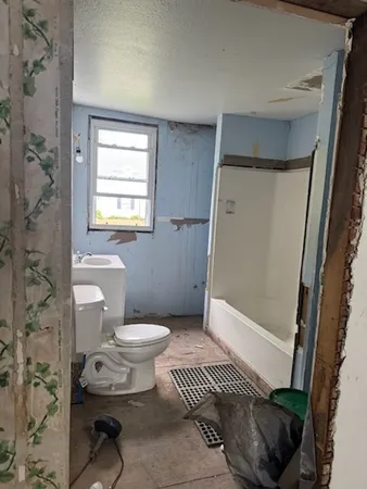 a bathroom with a toilet and a shower