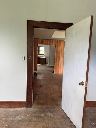 a view of a hallway with wooden shelves