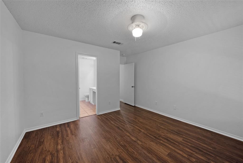 2910 Chisholm Trail Corinth, TX 76210 - Photo 17 of 30 a view of an empty room with wooden floor