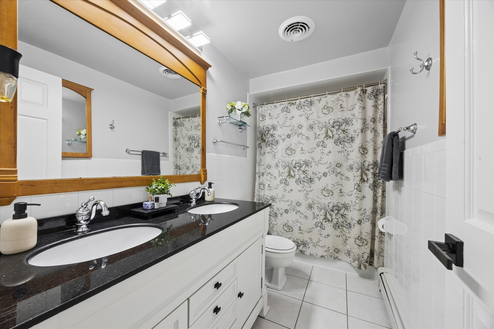 1240 South Lorraine Road, Unit 3B Wheaton, IL 60189 - Photo 13 of 17 a bathroom with a double vanity sink toilet mirror and shower