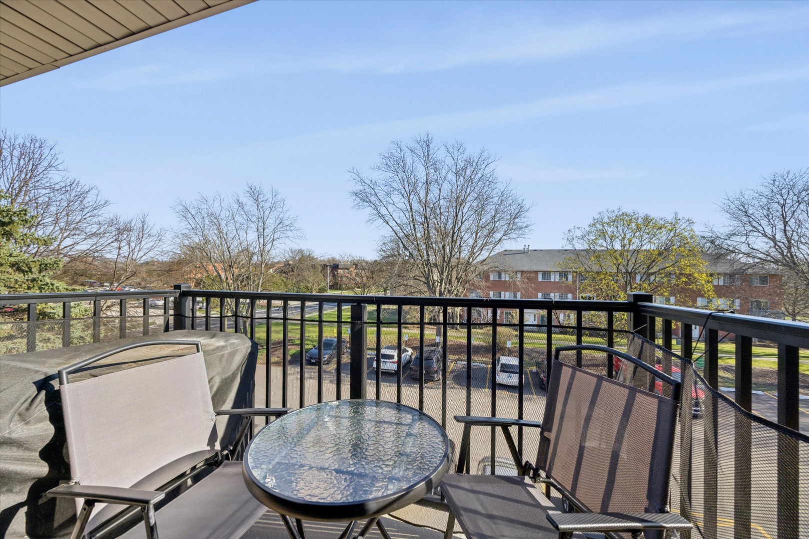 1240 South Lorraine Road, Unit 3B Wheaton, IL 60189 - Photo 14 of 17 a view of a balcony with a table and chairs