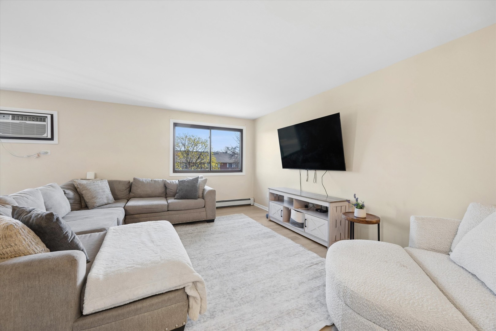 1240 South Lorraine Road, Unit 3B Wheaton, IL 60189 - Photo 3 of 17 a living room with furniture and a flat screen tv