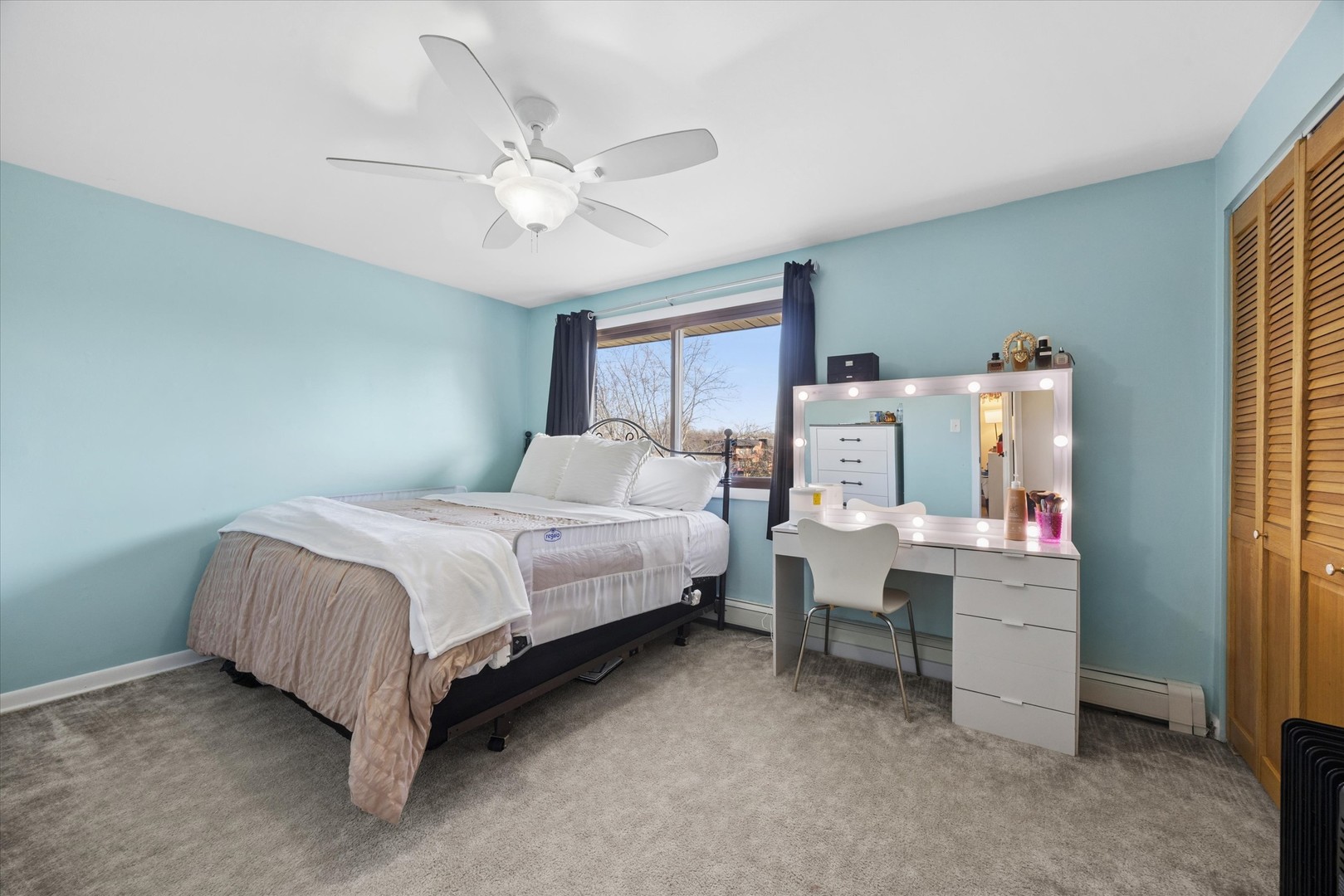 1240 South Lorraine Road, Unit 3B Wheaton, IL 60189 - Photo 10 of 17 a bedroom with a bed and a chandelier