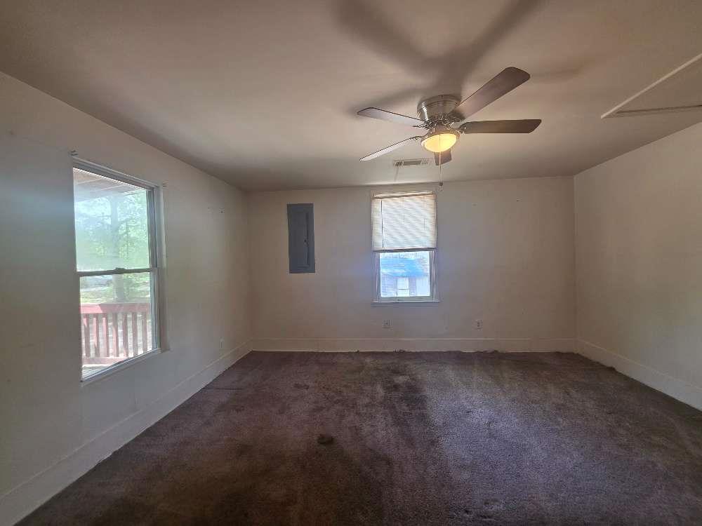 3127 Hendrix Circle Southwest Covington, GA 30014 - Photo 14 of 29 an empty room with ceiling fan and window
