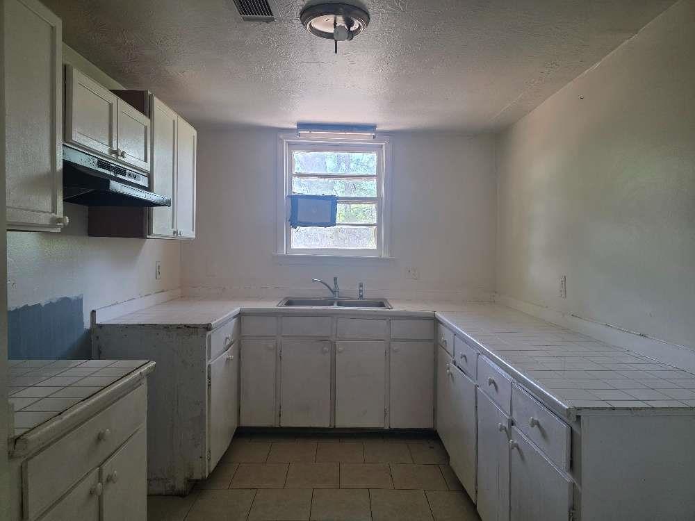 3127 Hendrix Circle Southwest Covington, GA 30014 - Photo 10 of 29 a kitchen with a sink stove and cabinets