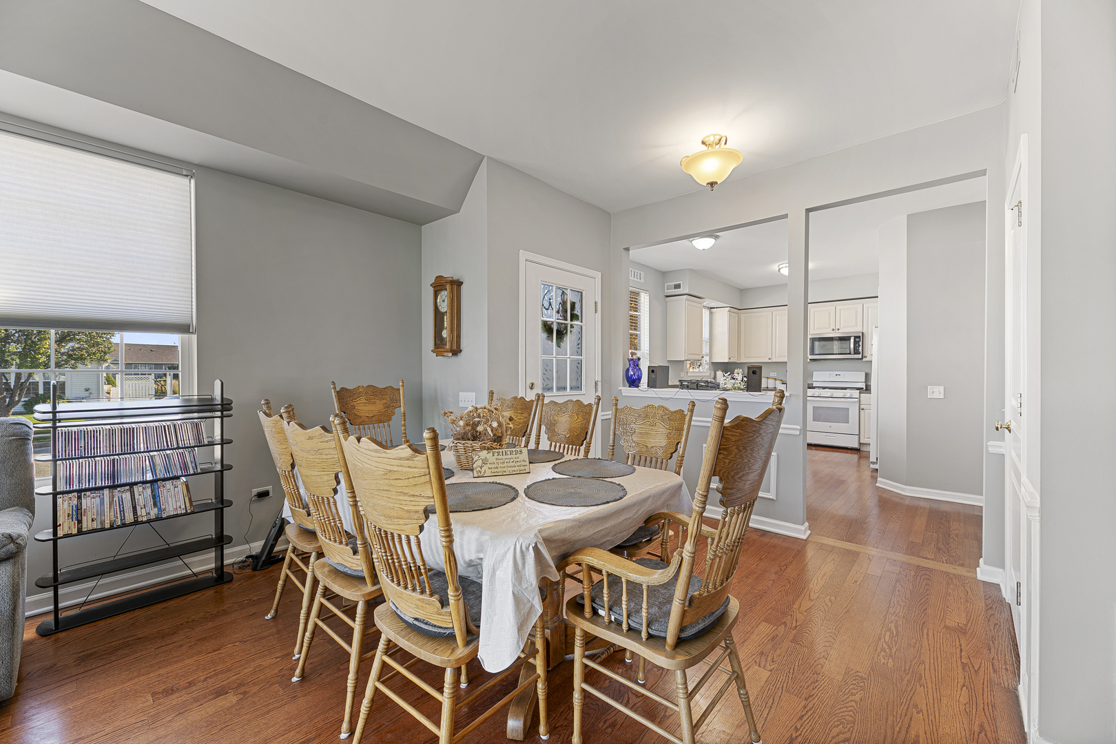 12963 Penefield Lane Huntley, IL 60142 - Photo 3 of 33 a view of a dining room with furniture and wooden floor