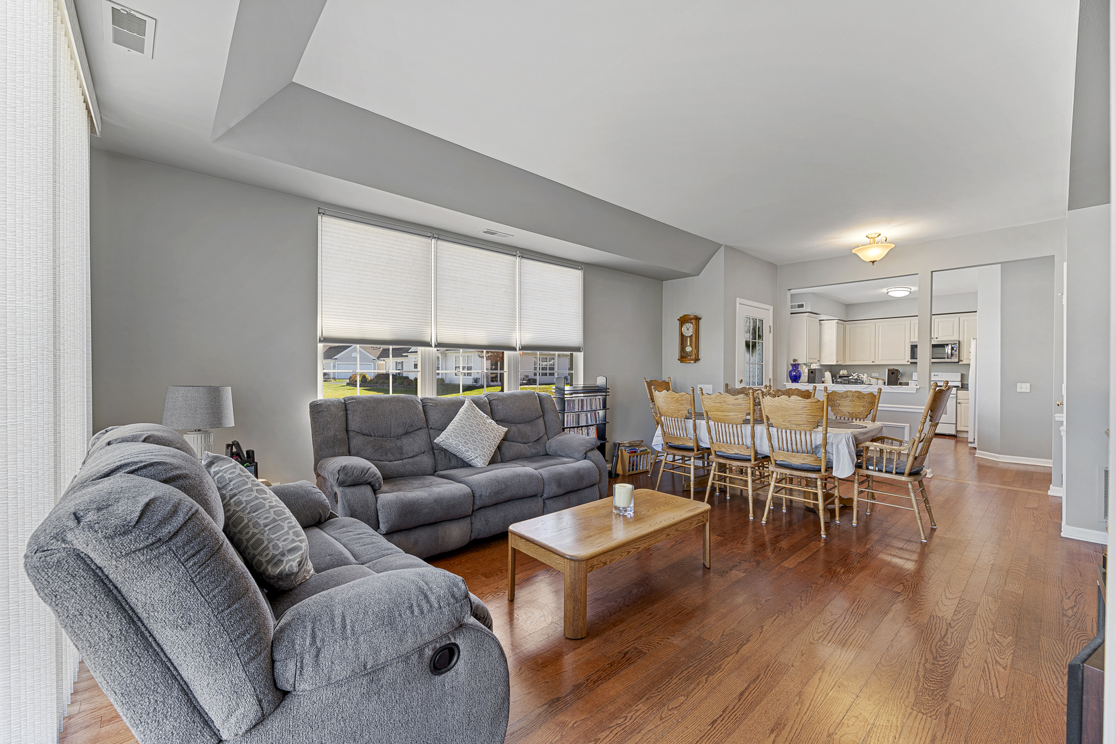 12963 Penefield Lane Huntley, IL 60142 - Photo 4 of 33 a living room with furniture wooden floor and a window