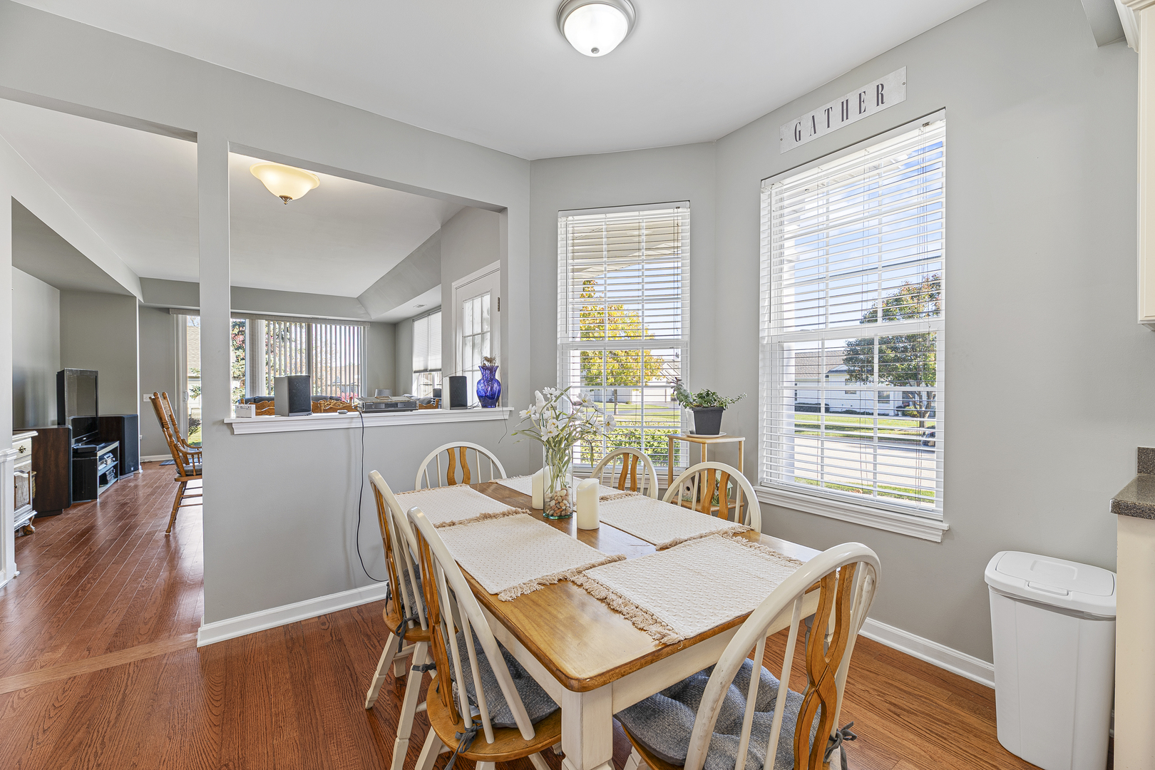 12963 Penefield Lane Huntley, IL 60142 - Photo 10 of 33 a view of a dining room with furniture window and wooden floor