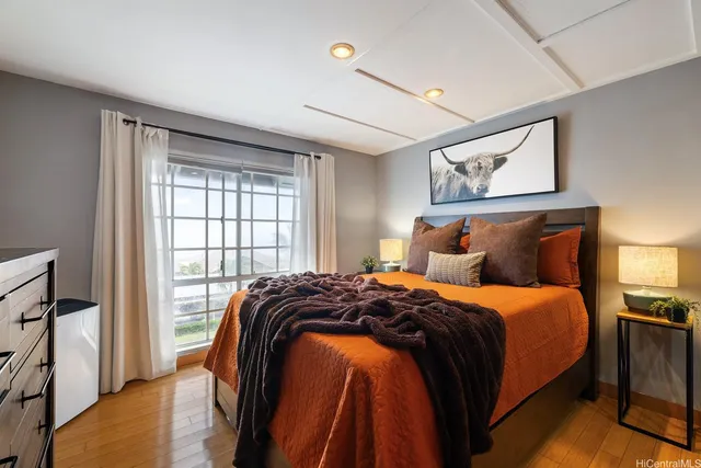 a bedroom with a bed and a painting on the wall