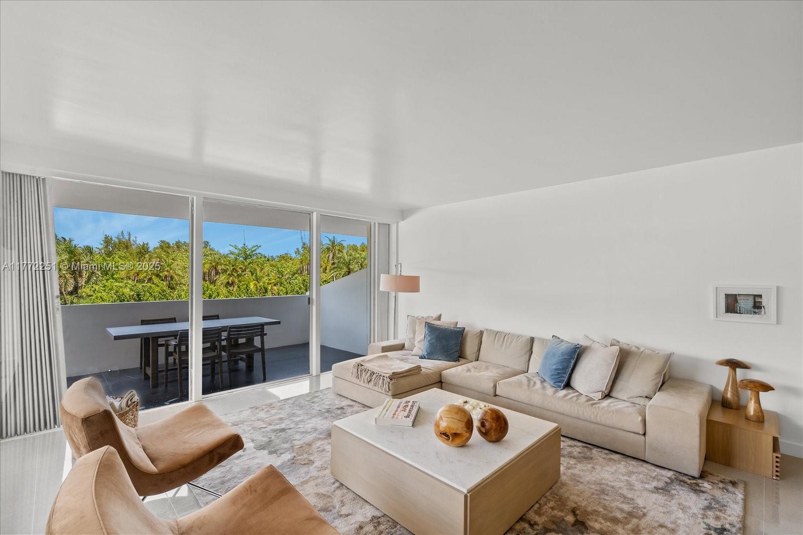 a living room with furniture a rug and a large window