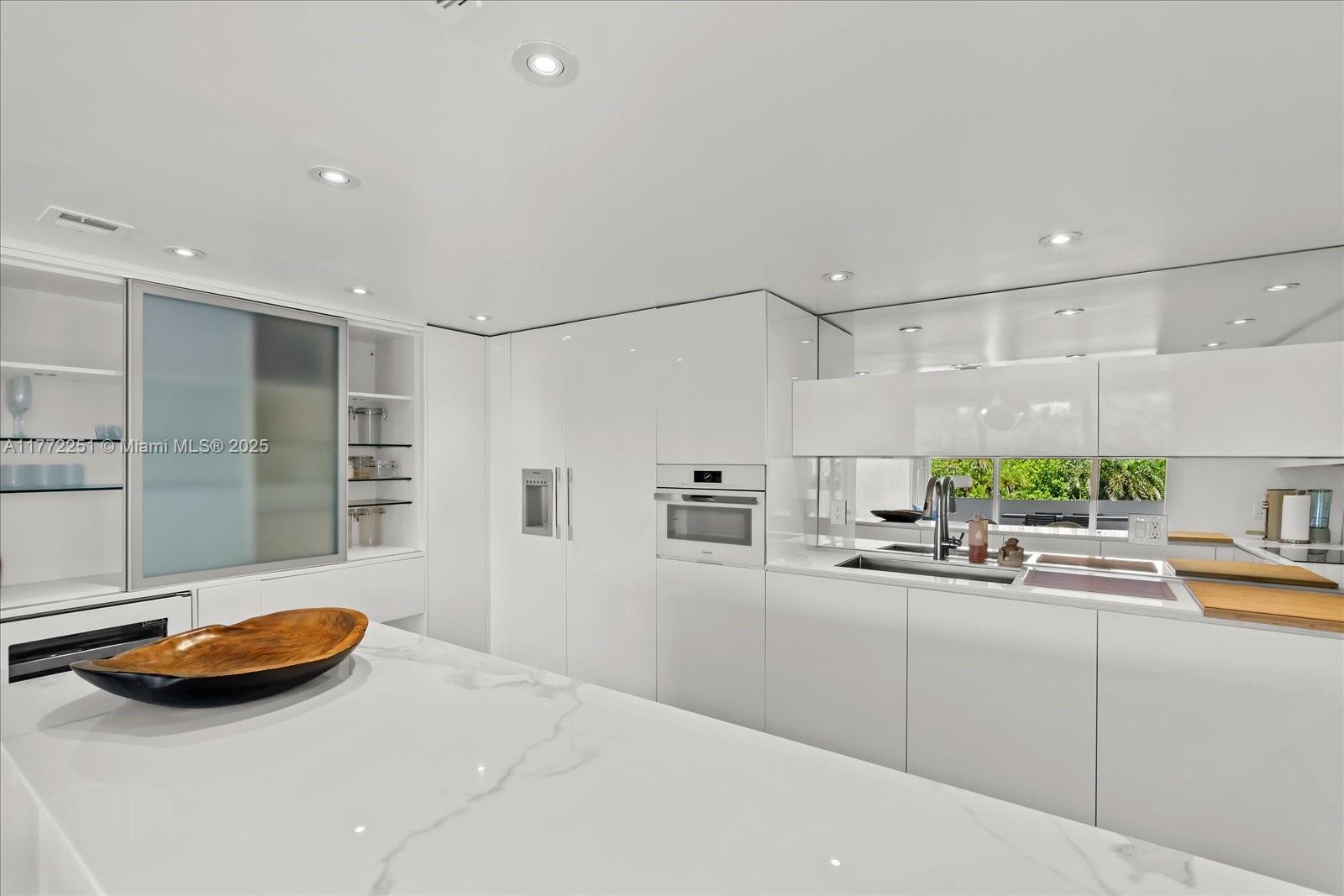 155 Ocean Ln Drive, Unit 208 Key Biscayne, FL 33149 - Photo 11 of 34 a kitchen with stainless steel appliances granite countertop a sink and a wooden cabinets