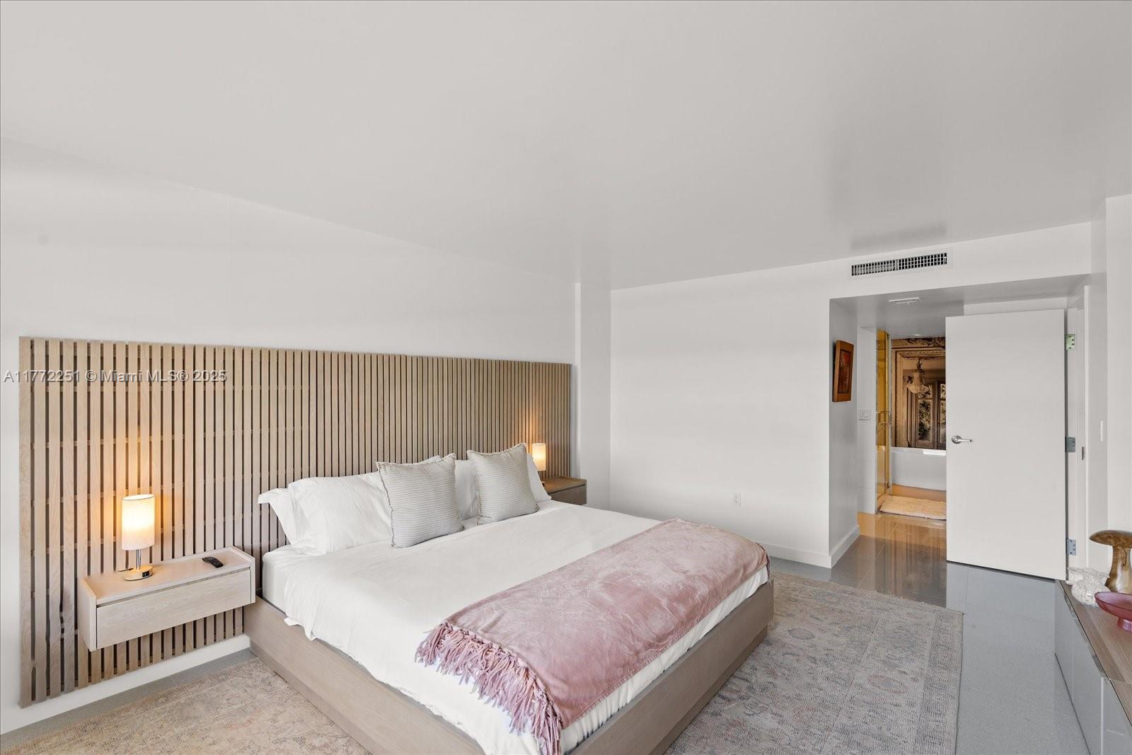 155 Ocean Ln Drive, Unit 208 Key Biscayne, FL 33149 - Photo 15 of 34 a bedroom with a bed and a lamp