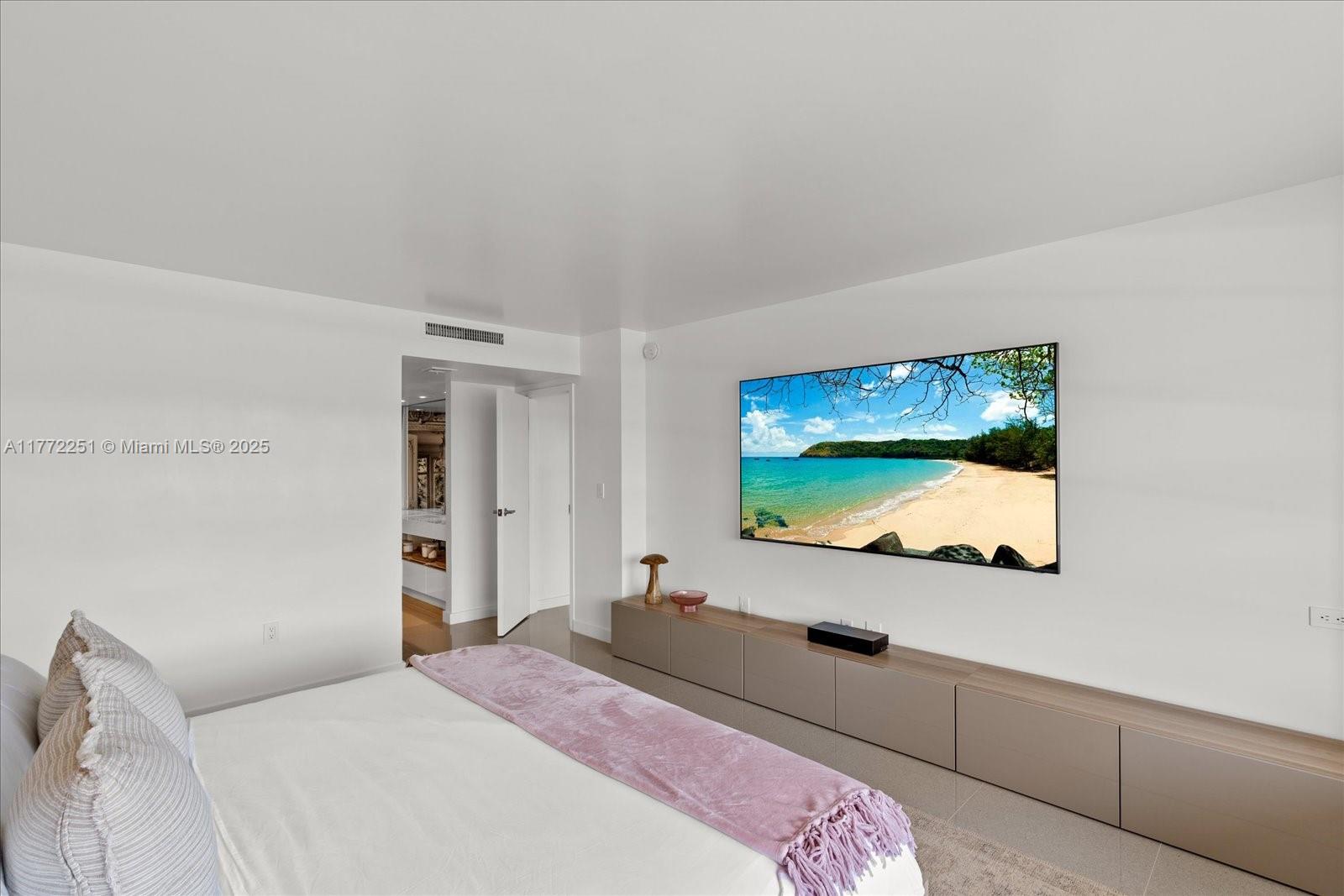 155 Ocean Ln Drive, Unit 208 Key Biscayne, FL 33149 - Photo 17 of 34 a bedroom with a bed and a flat screen tv
