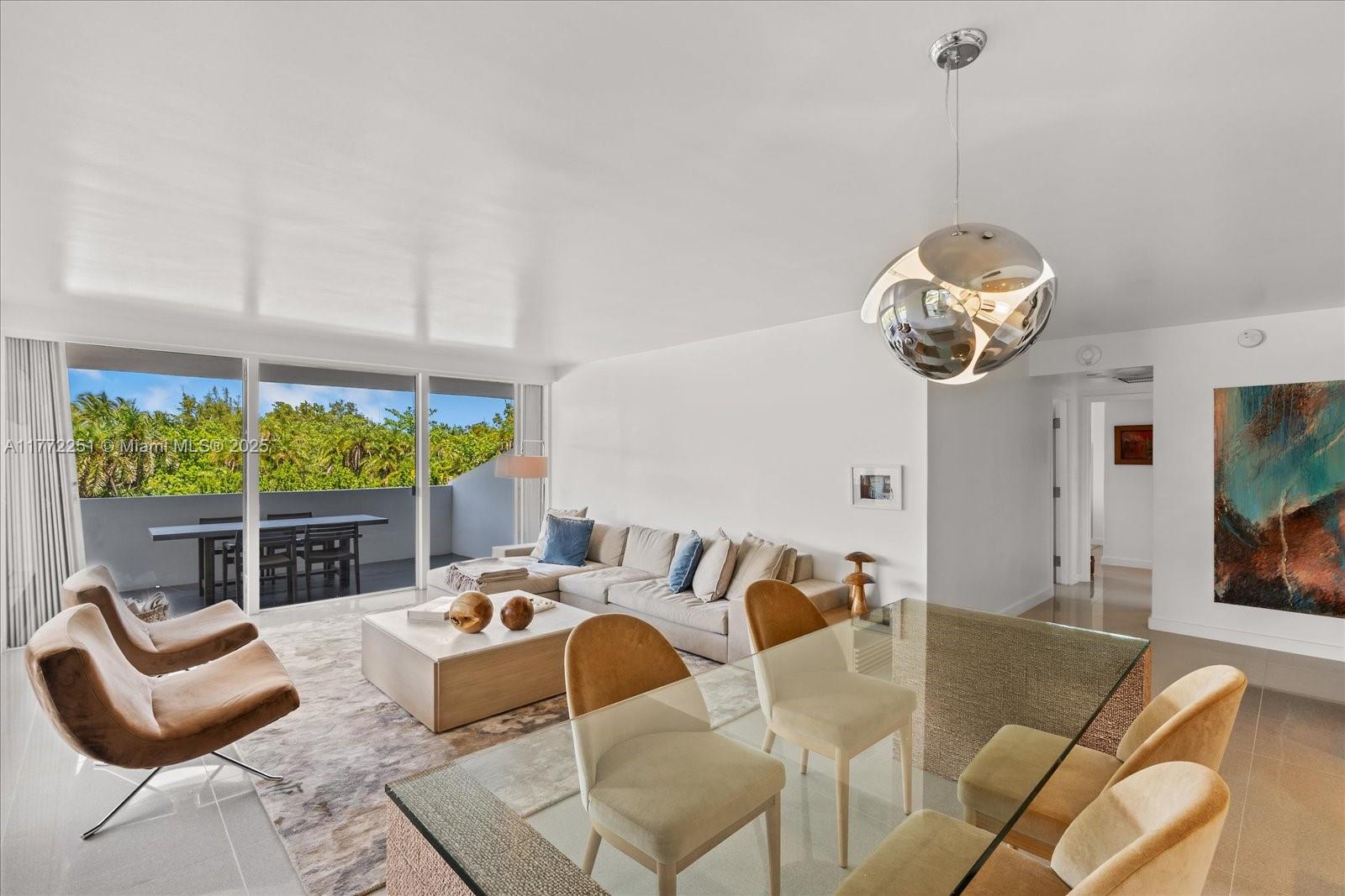 155 Ocean Ln Drive, Unit 208 Key Biscayne, FL 33149 - Photo 2 of 34 a living room with furniture chandelier and a large window