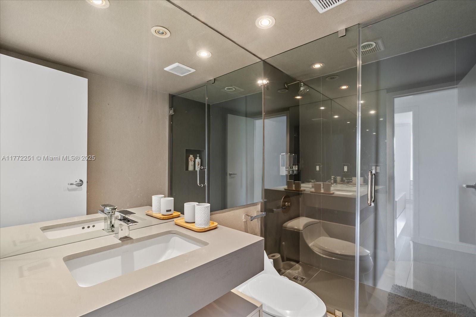 155 Ocean Ln Drive, Unit 208 Key Biscayne, FL 33149 - Photo 21 of 34 a bathroom with a sink mirror and toilet