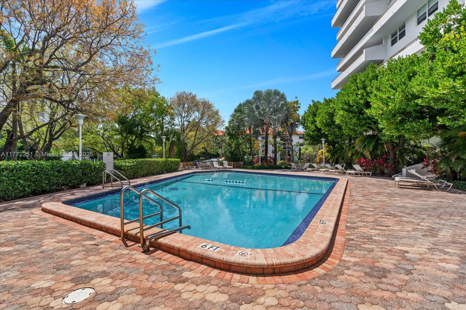 155 Ocean Ln Drive, Unit 208 Key Biscayne, FL 33149 - Photo 30 of 34 a view of a swimming pool with a patio