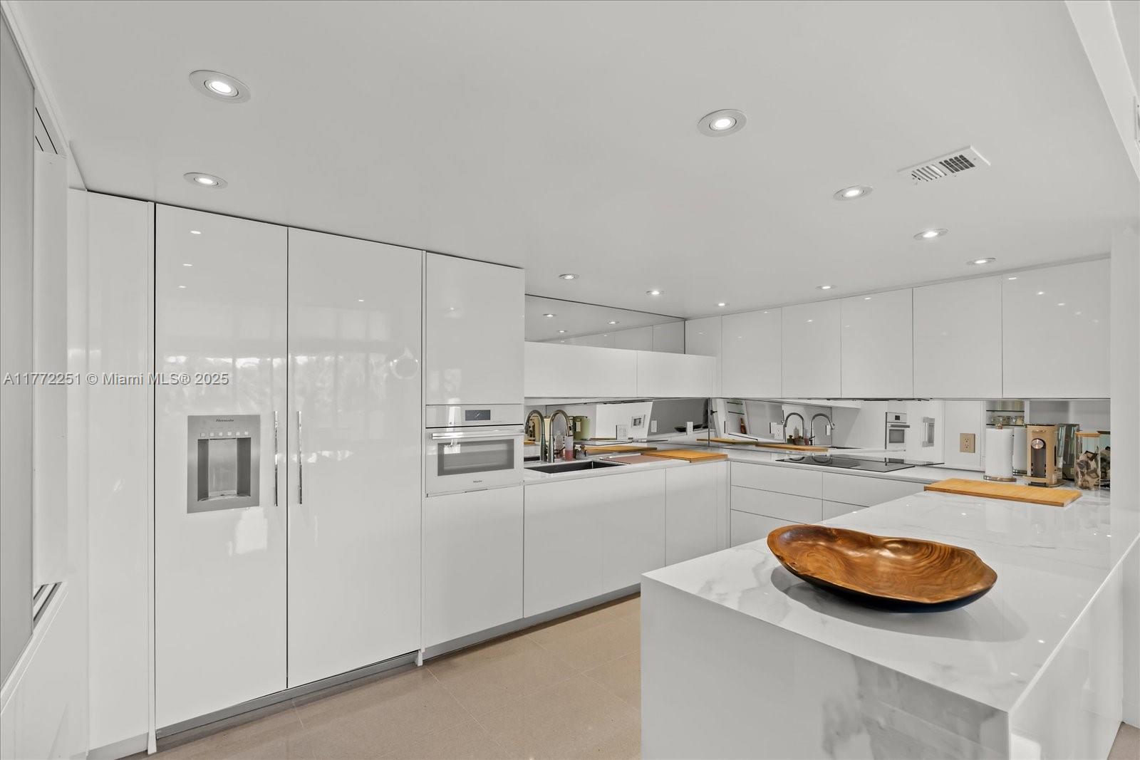 155 Ocean Ln Drive, Unit 208 Key Biscayne, FL 33149 - Photo 8 of 34 a kitchen with stainless steel appliances granite countertop a sink and refrigerator