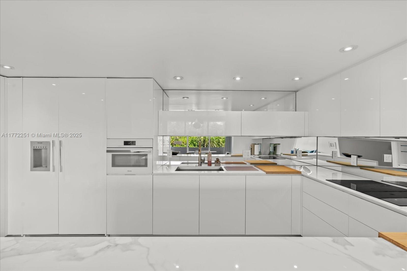 155 Ocean Ln Drive, Unit 208 Key Biscayne, FL 33149 - Photo 9 of 34 a kitchen with a sink and white cabinets