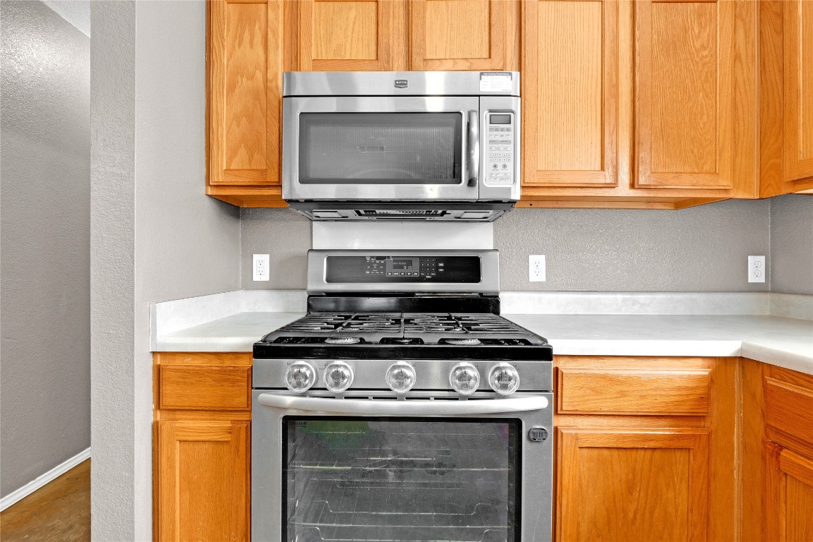 3007 Rainy River Drive Leander, TX 78641 - Photo 12 of 34 Kitchen with a textured wall, stainless steel appliances, and light countertops