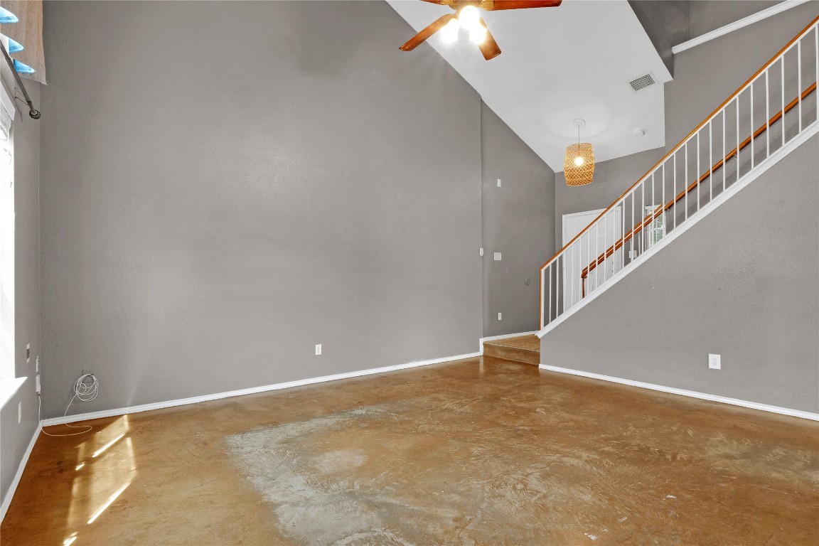 3007 Rainy River Drive Leander, TX 78641 - Photo 7 of 34 Living area featuring arched walkways, a ceiling fan, high vaulted ceiling, and concrete flooring