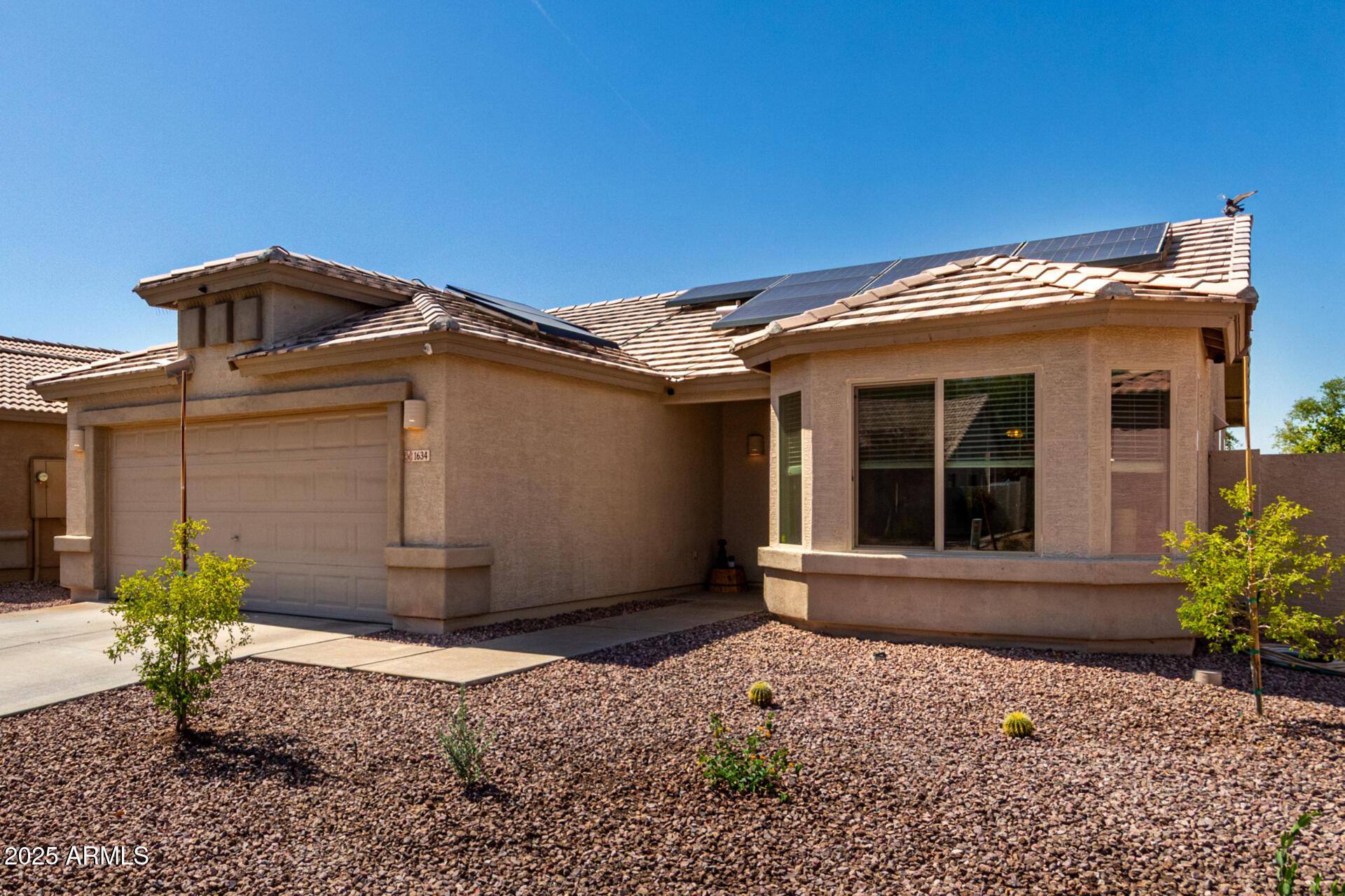 1634 East Harwell Road Phoenix, AZ 85042 - Photo 4 of 44 a view of a house with a small yard and potted plants