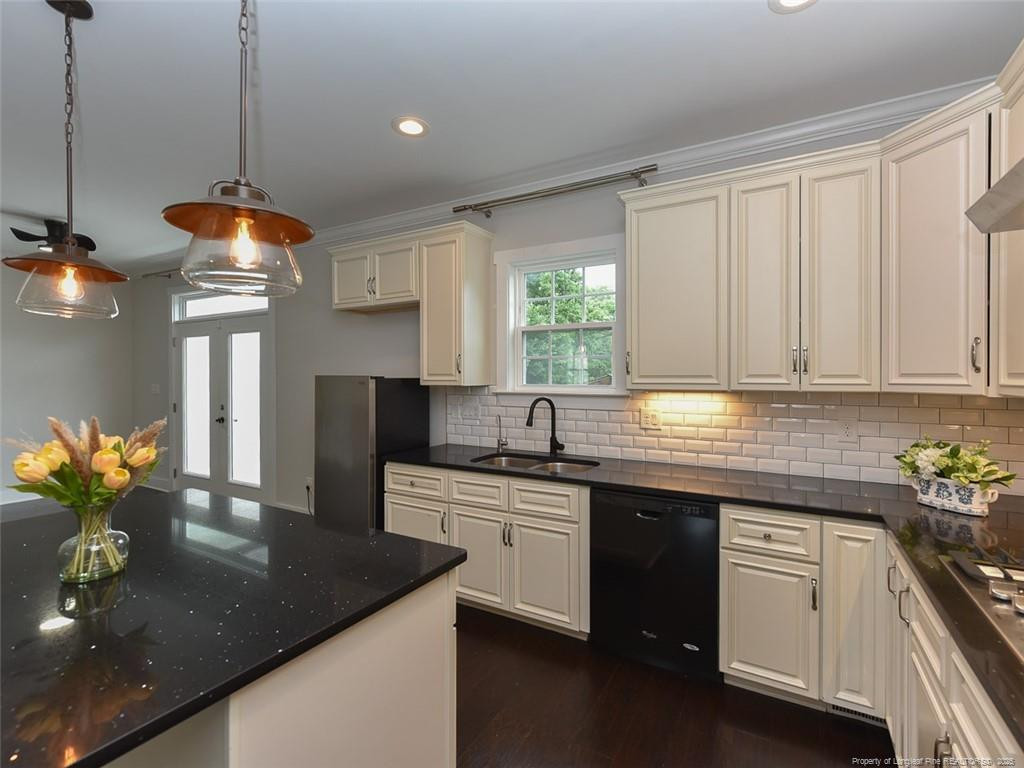 723 Lindley Drive Durham, NC 27703 - Photo 14 of 37 a kitchen with stainless steel appliances granite countertop a sink a stove and a counter space