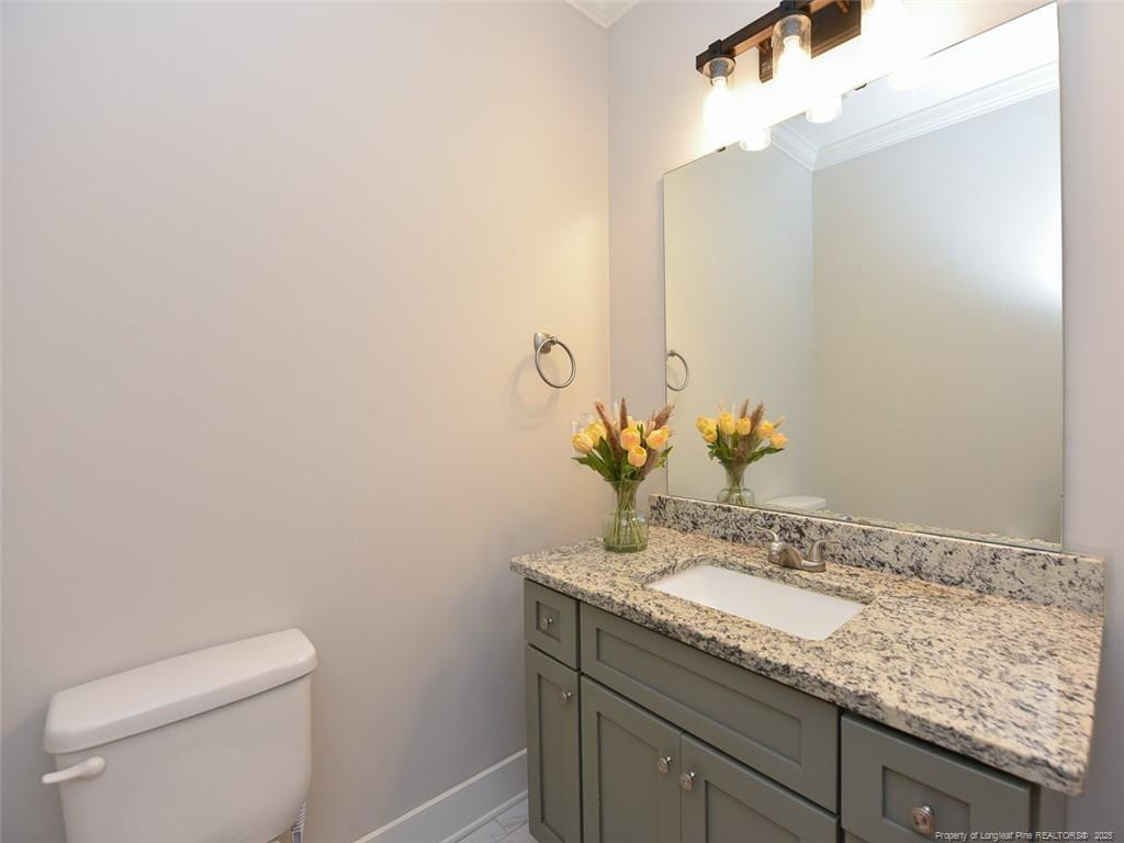 723 Lindley Drive Durham, NC 27703 - Photo 16 of 37 a bathroom with a granite countertop sink and a mirror