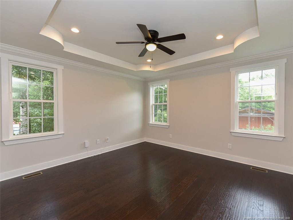 723 Lindley Drive Durham, NC 27703 - Photo 17 of 37 a view of an empty room with wooden floor and a window