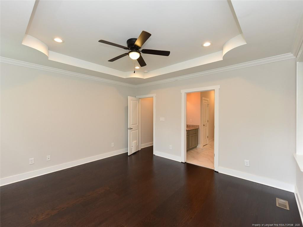 723 Lindley Drive Durham, NC 27703 - Photo 18 of 37 a view of an empty room with wooden floor and a ceiling fan
