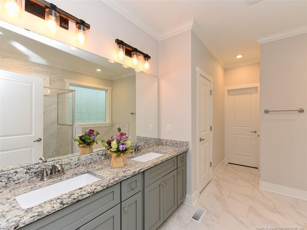 723 Lindley Drive Durham, NC 27703 - Photo 20 of 37 a bathroom with a granite countertop sink mirror and double
