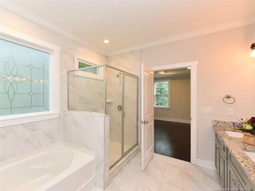 723 Lindley Drive Durham, NC 27703 - Photo 21 of 37 a bathroom with a granite countertop tub shower and sink