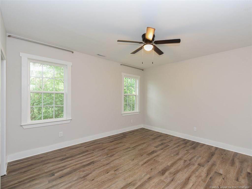723 Lindley Drive Durham, NC 27703 - Photo 23 of 37 a view of empty room with wooden floor and fan
