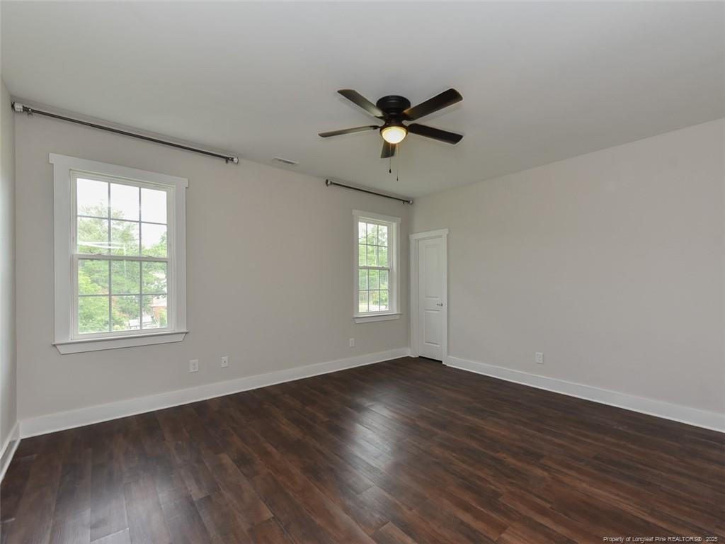 723 Lindley Drive Durham, NC 27703 - Photo 26 of 37 a view of empty room with wooden floor and fan