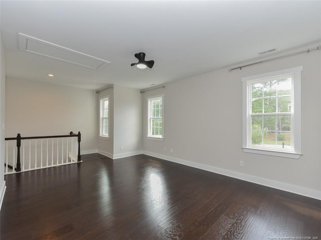 723 Lindley Drive Durham, NC 27703 - Photo 27 of 37 an empty room with wooden floor and windows
