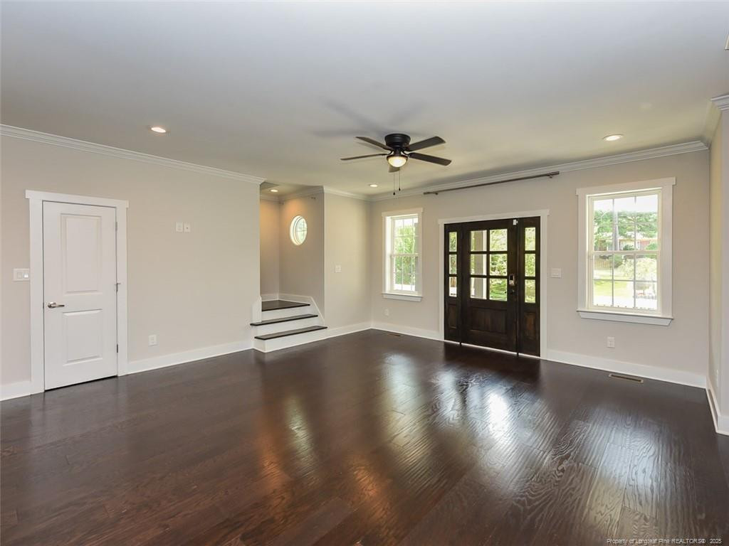 723 Lindley Drive Durham, NC 27703 - Photo 7 of 37 a view of an empty room with window and wooden floor
