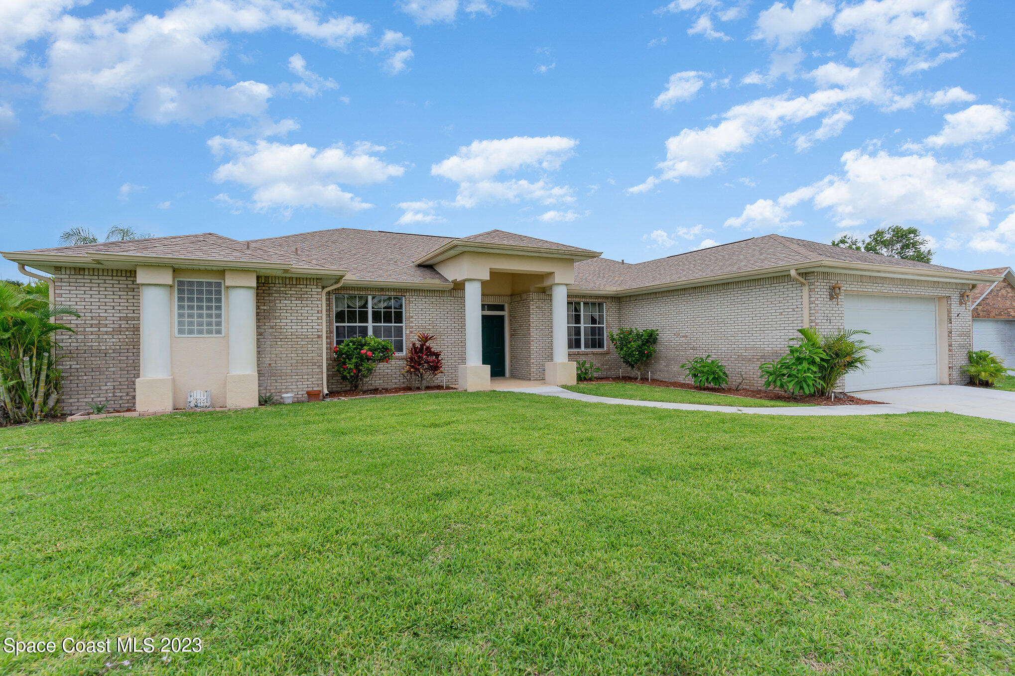 128 Palm Circle Melbourne, FL 32940 - Photo 1 of 30 a view of a house with a yard and potted plants
