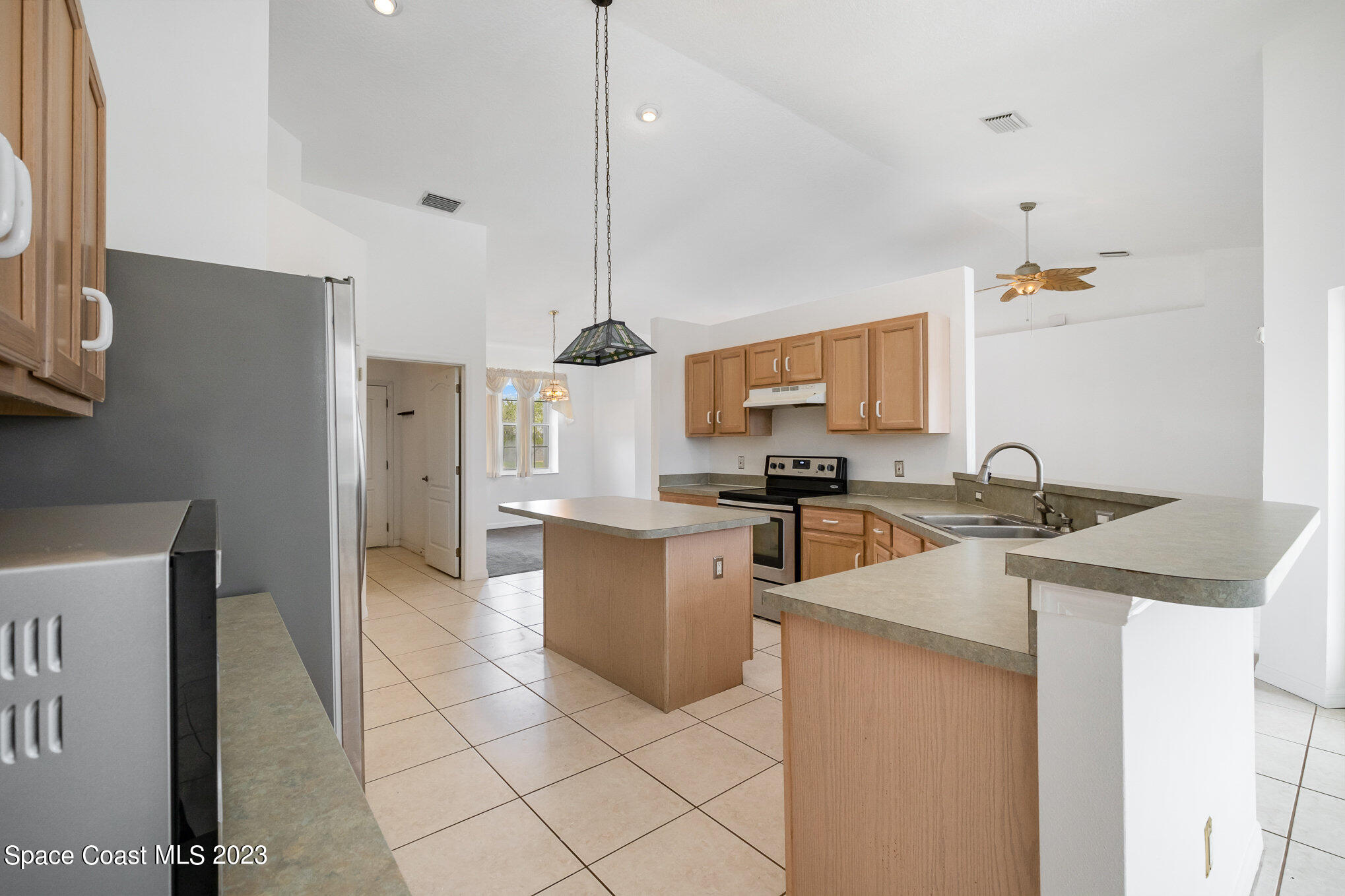 128 Palm Circle Melbourne, FL 32940 - Photo 12 of 30 a kitchen with a sink a counter top space and appliances