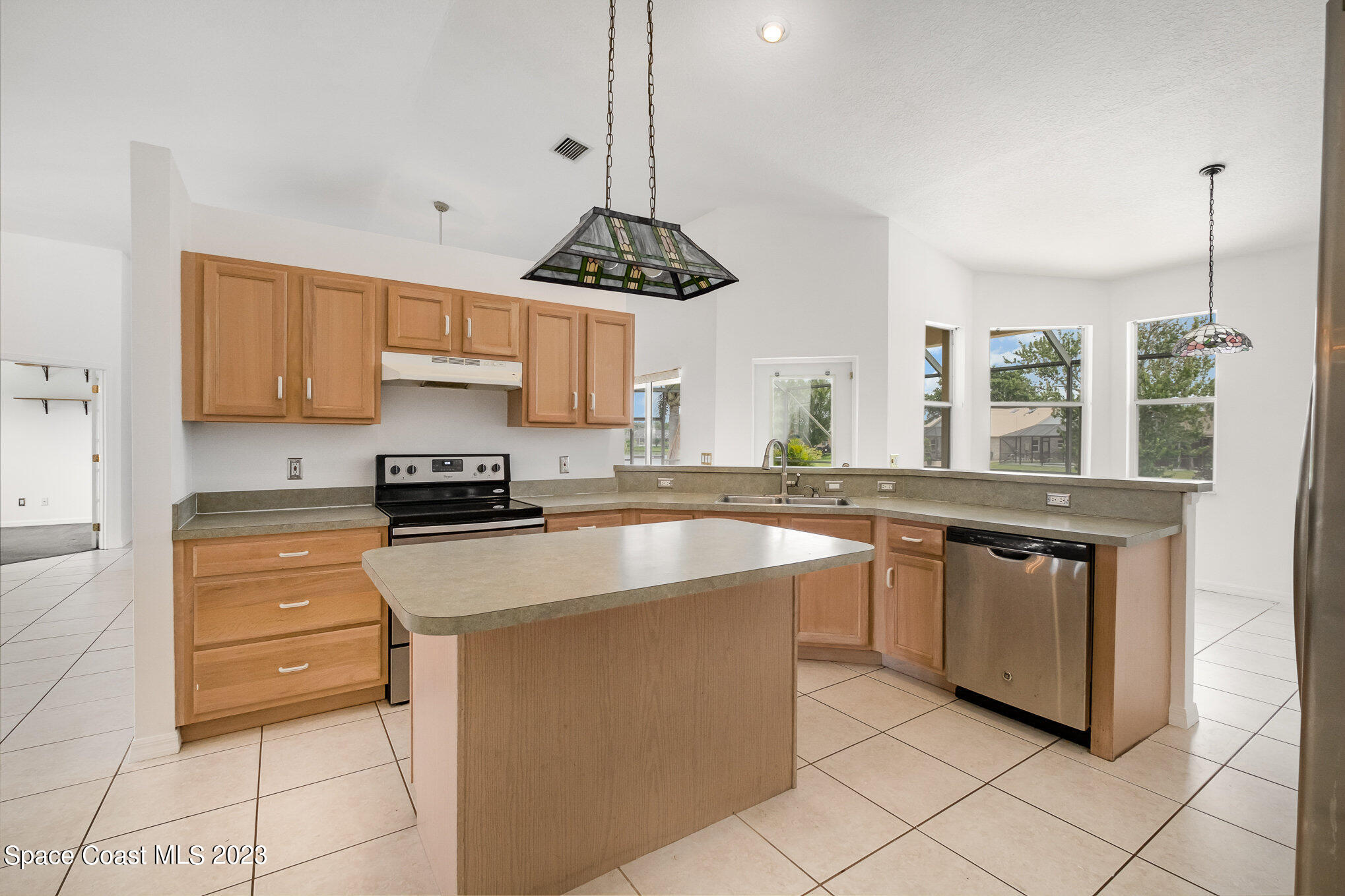 128 Palm Circle Melbourne, FL 32940 - Photo 14 of 30 a kitchen with stainless steel appliances granite countertop a sink a stove and a refrigerator