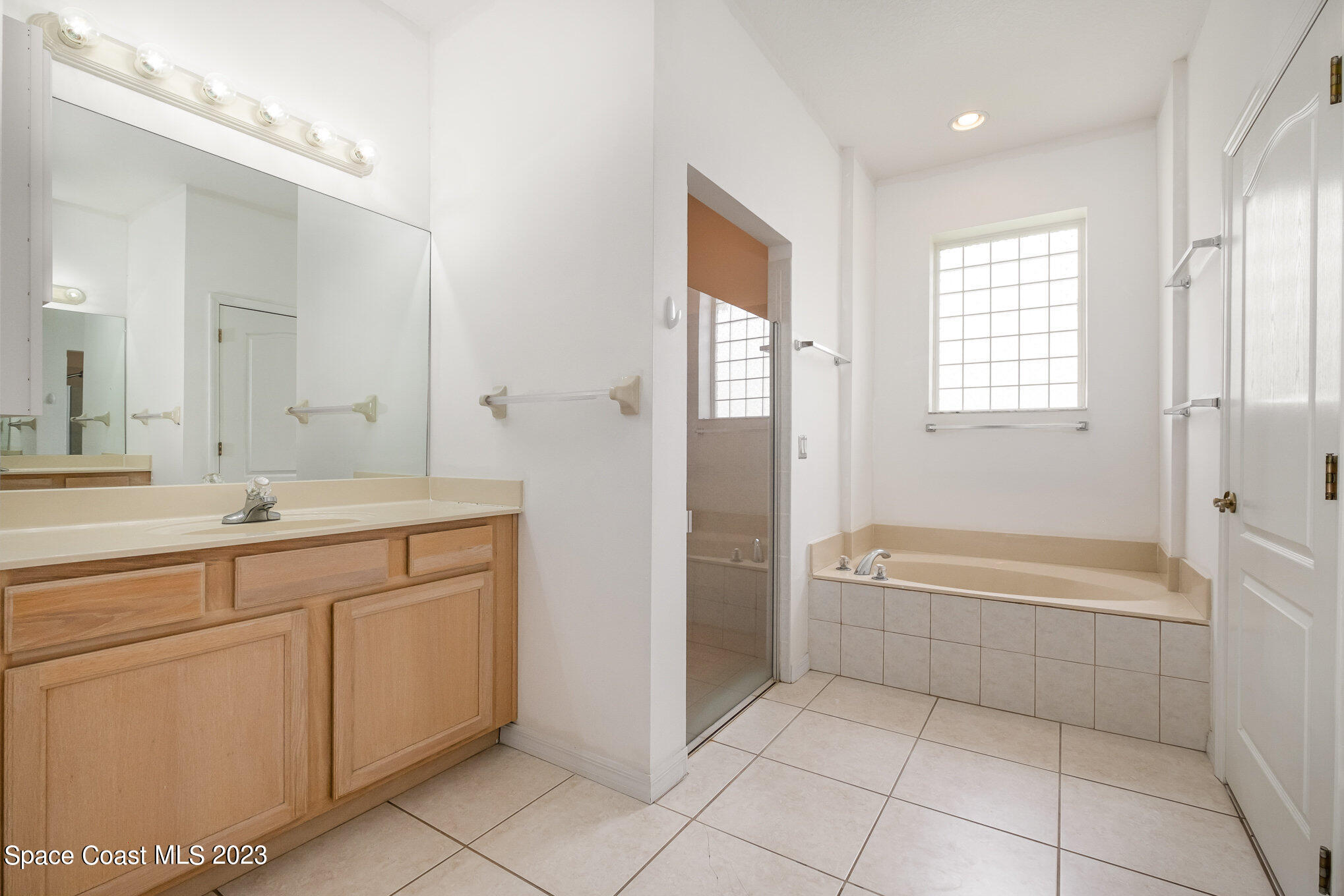 128 Palm Circle Melbourne, FL 32940 - Photo 18 of 30 a spacious bathroom with a tub sink shower and mirror